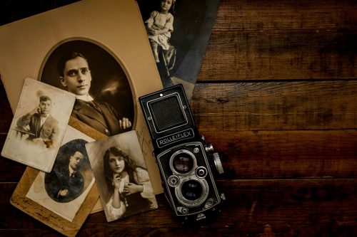 Old Rolleiflex camera surrounded by photos.